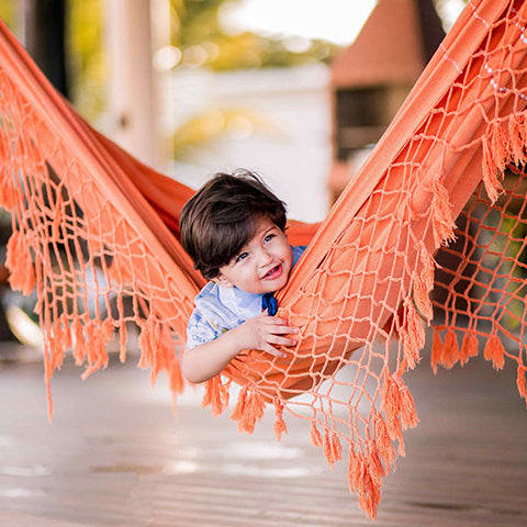 Child sitting in a hammock
