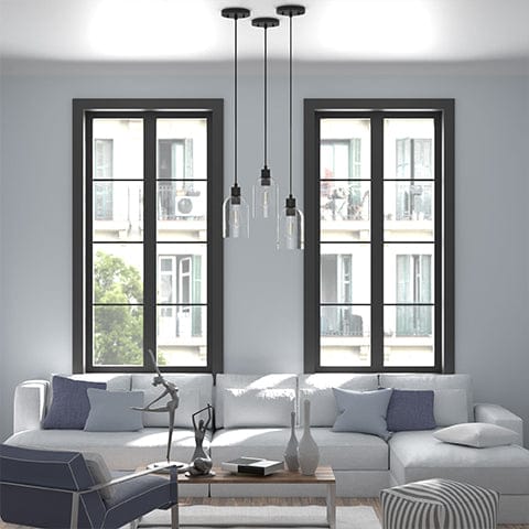 Lochemeade 1 light mini pendant in Natural Iron hanging in a modern living room space.