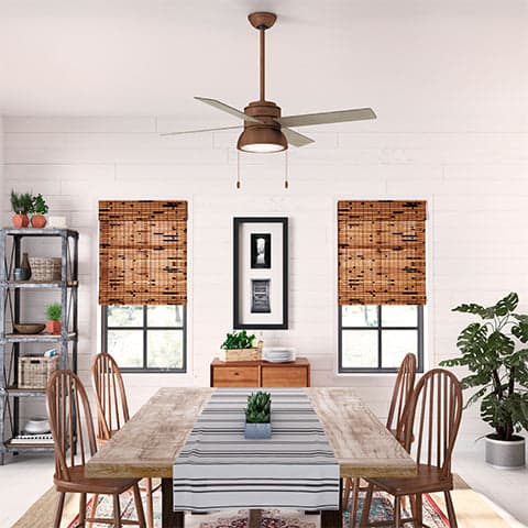 Loki fan in Weathered Copper with Barnwood blades hanging in a rustic, Bohemian space.
