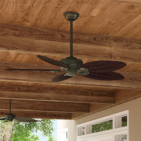 Bayview fan in Provencal Gold hanging in an outdoor space