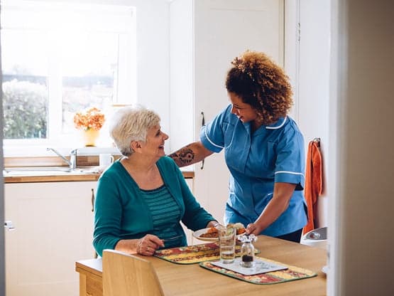 Nurse and patient discussing healthcare at a table