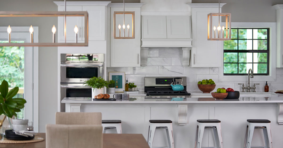 Two Brushed Nickel - Bleached Wood Squire Manor pendants in white kitchen