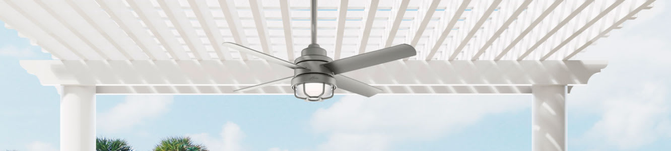 Outdoor ceiling fan mounted on pergola