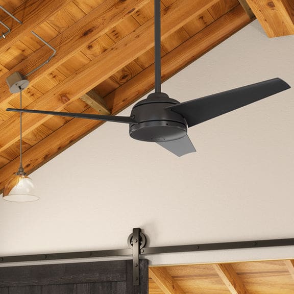 Trimaran in premier bronze finish mounted with a downrod on a wood ceiling.