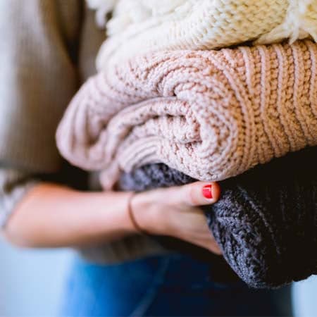 image of someone holding 3 fuzzy blankets