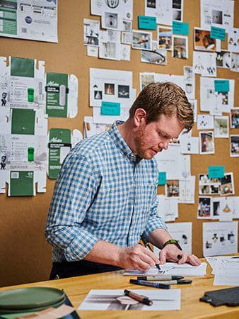 Head of design Patrick O'Connell sketching a fan in a design studio.