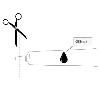 scissors showing where to cut the oil bottle