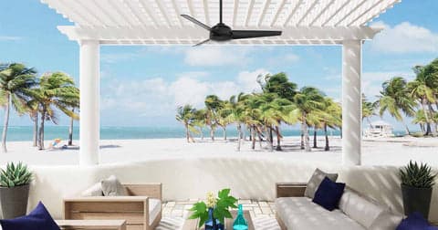 Trimaran outdoor fan in Matte Black hanging on beach side pergola.
