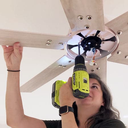 Woman removing the fan's blades.