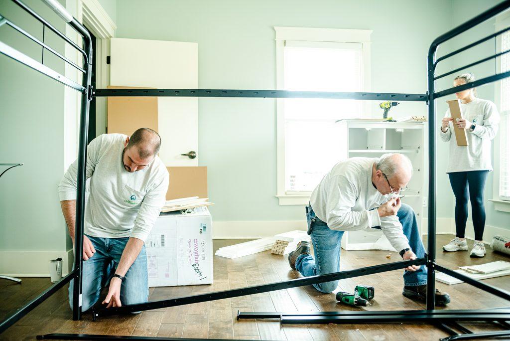 Hunter Fan Company employees building a bedframe during Dorothy Day House of Memphis Huntervention