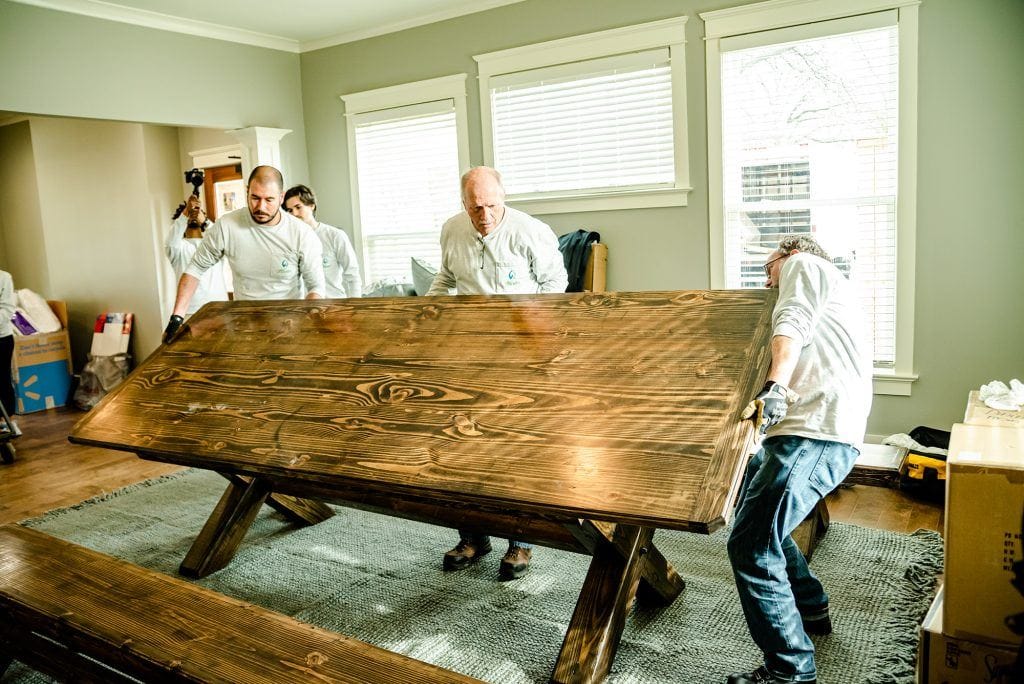 Hunter Fan Company employees moving a bench during the Dorothy Day House of Memphis Huntervention